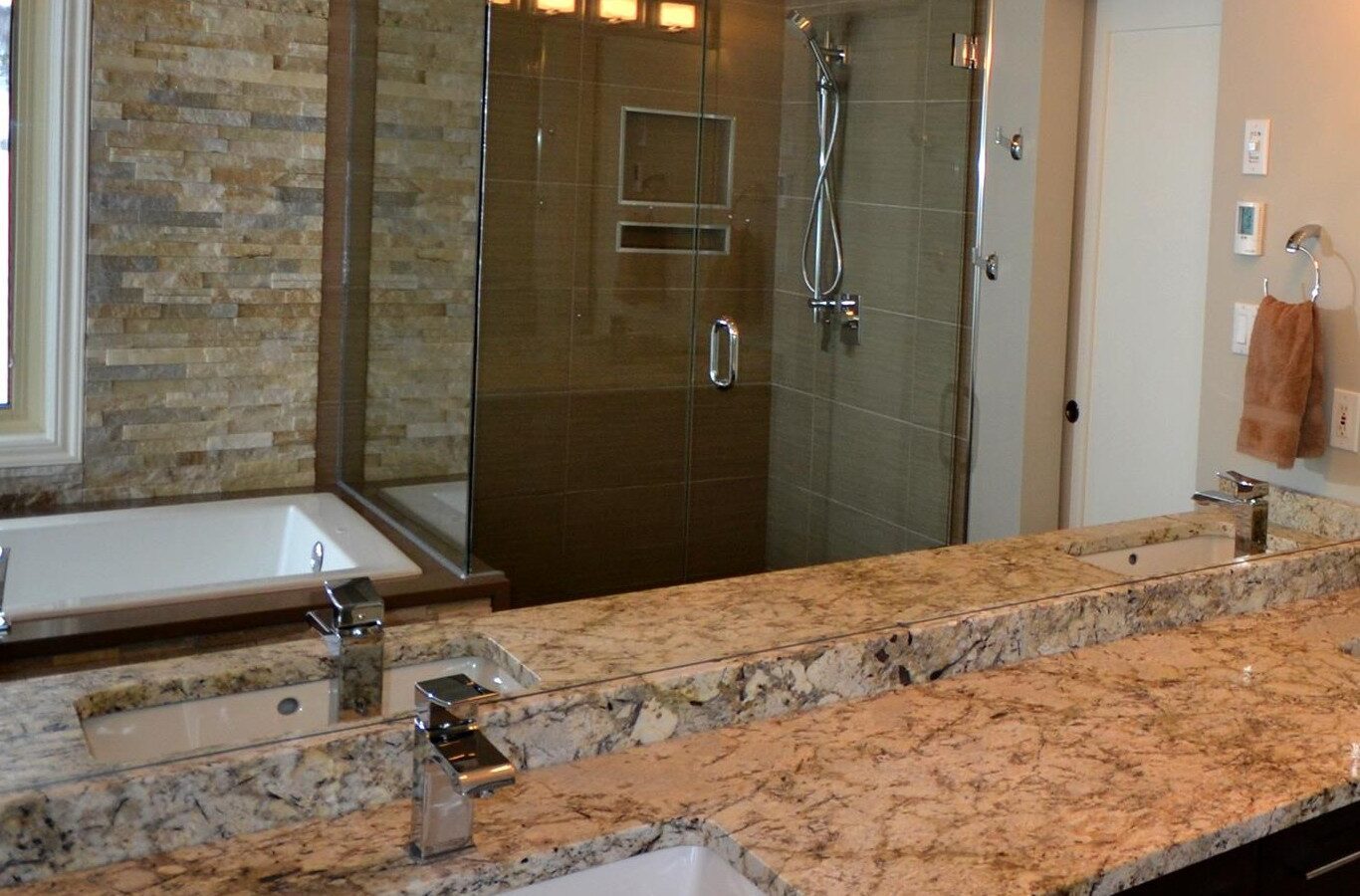 Bathroom with a stacked stone feature wall and a tiled shower